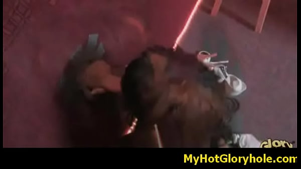Ebony girl gives interracial blowjob through gloryhole