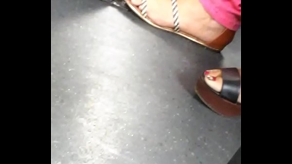 woman showing off her mature feet in candid wedges and sandals