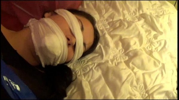 Claudia tied up in suit gagged bondage tape