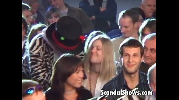 Brunette girl seduces crowd on stage at live sex show