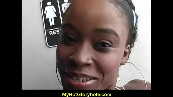 Ebony woman sucks cock at the gloryhole