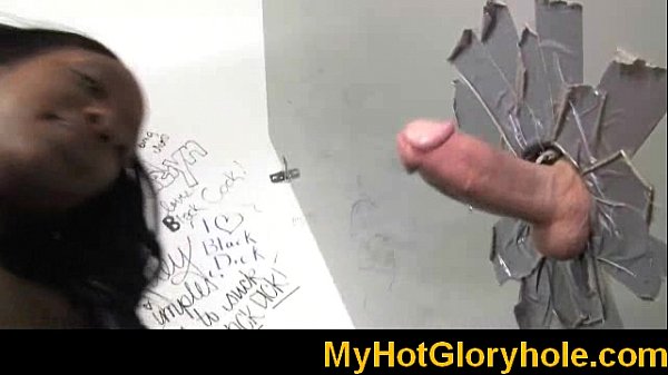 Ebony babe sucks white monster cock through gloryhole