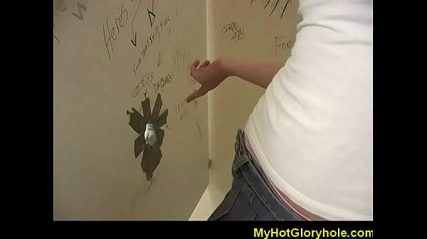 Ebony woman blows black cock in a gloryhole
