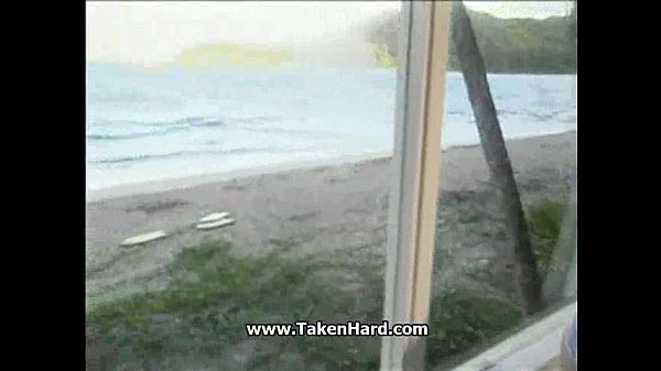 woman licks another woman's pussy on a beach with a beautiful ocean view