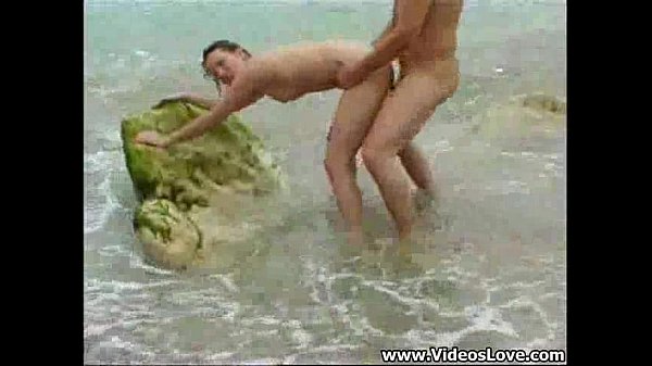 Brunette gets anal on the beach