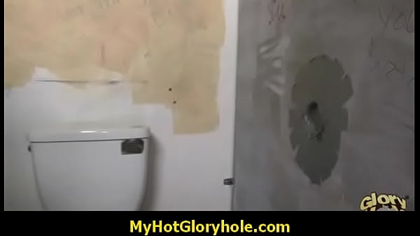 Ebony woman with huge tits deepthroats a black man at a gloryhole