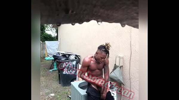 Neighbors watch Handsomedevan jerk his big black cock in the rain