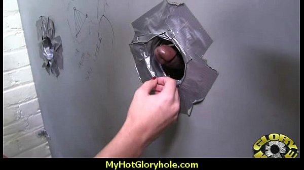 White milf blows black cock in a glory hole scene