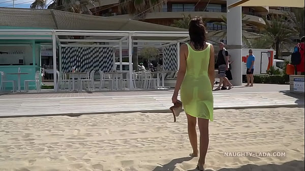 Naughty Lada in see-through dress at beach