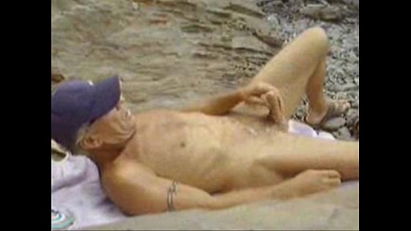 Cocaman strips naked on outdoor rocks