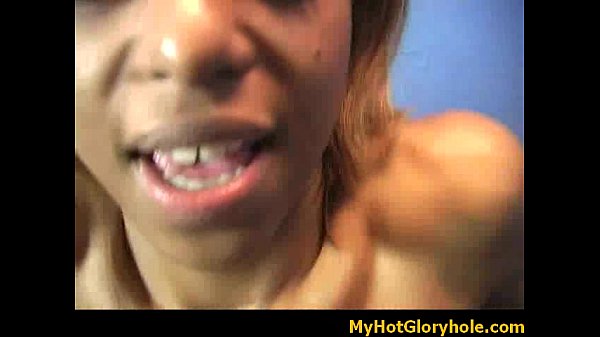 Ebony woman sucks cock at glory hole
