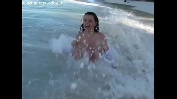 Milena Velba wearing a beach dress gets teased on the beach