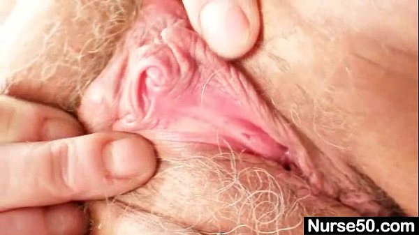 Grandma in uniform spreads her hairy blond pussy with sex toys and speculum