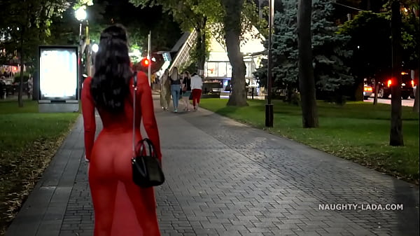 Naughty Lada goes braless in a transparent red dress in public
