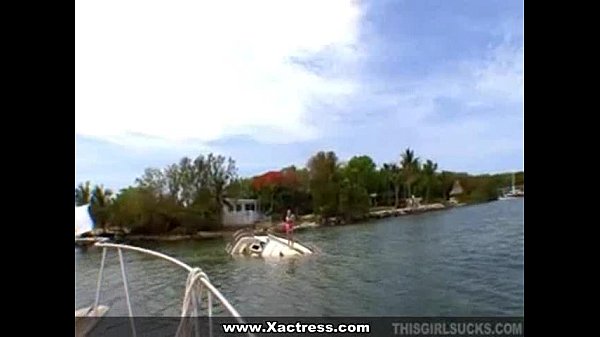 Redhead gives blowjob on a boat